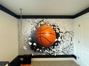 Basketball bursting through cracked concrete on a bedroom wall mural framed by black painted stripes